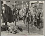 Half-made garments on the racks, awaiting final operations of the machines, in cooperative garment factory, Hightstown, New Jersey