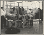 Steam pressing the cloth is one process in manufacturing women's coats at Jersey Homesteads, Hightstown