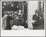 Group of men on 7th Avenue and 28th Street, New York City