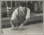 Louis Gushen, chief cutter in the cooperative garment factory at Jersey Homesteads, is cutting the pattern for a woman's coat. Hightstown, New Jersey