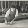 Louis Gushen, chief cutter in the cooperative garment factory at Jersey Homesteads, is cutting the pattern for a woman's coat. Hightstown, New Jersey