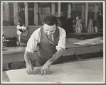 Louis Gushen, chief cutter in the cooperative garment factory at Jersey Homesteads, is cutting the pattern for a woman's coat. Hightstown, New Jersey