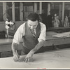 Louis Gushen, chief cutter in the cooperative garment factory at Jersey Homesteads, is cutting the pattern for a woman's coat. Hightstown, New Jersey