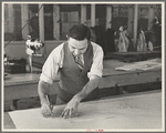 Louis Gushen, chief cutter in the cooperative garment factory at Jersey Homesteads, is cutting the pattern for a woman's coat. Hightstown, New Jersey