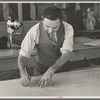 Louis Gushen, chief cutter in the cooperative garment factory at Jersey Homesteads, is cutting the pattern for a woman's coat. Hightstown, New Jersey