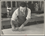 Louis Gushen, chief cutter in the cooperative garment factory at Jersey Homesteads, is cutting the pattern for a woman's coat. Hightstown, New Jersey