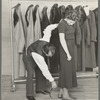 Measuring girl for a coat in cooperative garment factory at Jersey Homesteads, Hightstown, New Jersey