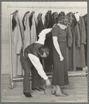 Measuring girl for a coat in cooperative garment factory at Jersey Homesteads, Hightstown, New Jersey