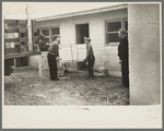 Abe Lipsky, farm foreman (left), has moved into his new home after living in temporary quarters at Jersey Homesteads for more than a year. He is being helped in the moving by Harry Katzenellenbogen, another farmer