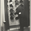 Mr. Leefer, manager of the millinery department, arranges hats in the New York City showroom