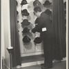 Mr. Leefer, manager of the millinery department, arranges hats in the New York City showroom