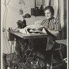 Woman at sewing machine in New York City tailor shop on University Place near 11th Street