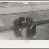 Children playing in the gutter on 139th Street just east of St. Anne's Avenue, Bronx, New York