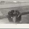 Children playing in the gutter on 139th Street just east of St. Anne's Avenue, Bronx, New York