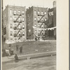 Apartment houses as viewed through vacant lot. In vicinity of 139th Street just east of St. Anne's Avenue Bronx, New York