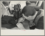 Closeup of man working sewing machine in garment factory, Jersey Homesteads, Hightstown, New Jersey