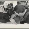 Closeup of man working sewing machine in garment factory, Jersey Homesteads, Hightstown, New Jersey