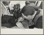 Closeup of man working sewing machine in garment factory, Jersey Homesteads, Hightstown, New Jersey