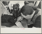 Closeup of man working sewing machine in garment factory, Jersey Homesteads, Hightstown, New Jersey