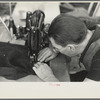 Closeup of man working sewing machine in garment factory, Jersey Homesteads, Hightstown, New Jersey