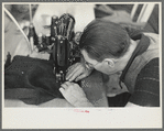 Closeup of man working sewing machine in garment factory, Jersey Homesteads, Hightstown, New Jersey