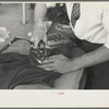 Closeup of presser's hands, Jersey Homesteads factory, Hightstown, New Jersey
