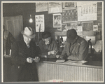 The weighmaster, his assistant and customers, weighing-in room, Aledo, Illinois