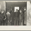 Farmers in shed at country auction near Aledo, Mercer County, Illinois