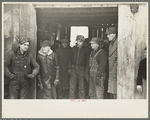 Farmers in shed at country auction near Aledo, Mercer County, Illinois