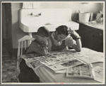 Children reading Sunday papers, Rustan brothers' farm near Dickens, Iowa. Note convenience of running water in background. This farm was formerly owner operated but they are now tenants of Metropolitan Life