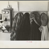 Garments hanging near telephone in Rustan brothers' farm near Dickens, Iowa