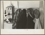 Garments hanging near telephone in Rustan brothers' farm near Dickens, Iowa