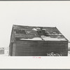Corn crib on Joe Beving's farm near Dickens, Iowa. Note condition of roof