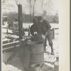 Farmers preparing "warm drink" for their hogs. Temperature: 15 below zero. Rustan Brothers farm near Dickens, Iowa, owned by Metropolitan Life Insurance Company. This farm was formerly owned by Rustan's father-in-law who built all the buildings