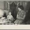 Mrs. Charles Benning and baby in their shack home at Shantytown, Spencer, Iowa