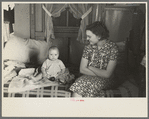 Mrs. Charles Benning and baby in their shack home at Shantytown, Spencer, Iowa