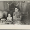 Mrs. Charles Benning and baby in their shack home at Shantytown, Spencer, Iowa