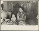 Mrs. Charles Benning and baby in their shack home at Shantytown, Spencer, Iowa