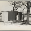 Marcus Miller in front of the shack he built for himself, Spencer, Iowa