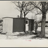 Marcus Miller in front of the shack he built for himself, Spencer, Iowa