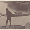 Esquimaux carrying his kayak to the water to start on hunt