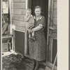 Mrs. Paul Rauhauser and one of her seven children in their home at Ruthven, Iowa