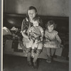 Mrs. Paul Rauhauser and two of her seven children in their home at Ruthven, Iowa