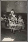 Mrs. Paul Rauhauser and two of her seven children in their home at Ruthven, Iowa