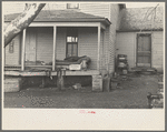 Front porch of house occupied by Mrs. Mary Kelsheiner and sons, Miller Township, Woodbury County, Iowa