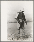 Levee worker during the flood, on a raw day with a thirty-mile wind. These men are very cold and almost exhausted from constant work