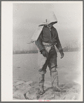 Levee worker during the flood, on a raw day with a thirty-mile wind. These men are very cold and almost exhausted from constant work