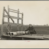 Tip Estes loading tile on a wagon, Fowler, Indiana