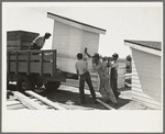 Southeast Missouri Farms Project. Loading completed privy houses on truck for delivery to site