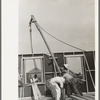Southeast Missouri Farms Project. House erection. Placing gin pole to erect the gable end